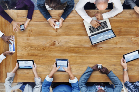 A group of people meeting around a table.